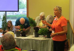 Nancy Norris coaching clinic attendees in clipping conifers.  Click for bigger picture.
