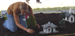 Molly planting trees in mulch. Click for bigger photo.
