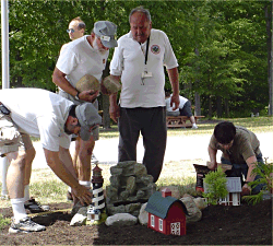 Volunteers from NOGRS are doing the heavy lifting in this photo. A young volunteer from the audience is setting little people out. If you know who the young volunteer is, contact us using the link at the bottom of this page, and we'll send you a 3x5 copy of this photo.  Click for bigger picture.