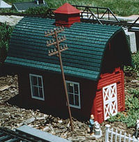 North States Red Barn Bird Feeder, with base removed, installed on a garden railroad. Click for bigger photo.