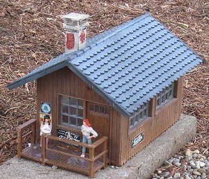 The top of a Pola switch tower is relabeled as a cafe and added to James' tiny village.  Click for bigger photo.
