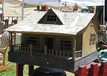 This house is made of tinplated sheet steel.  I included it as a folk-art house because it looks home-made.  Maybe a family commissioned a model of their home from a tinsmith.  Click for bigger picture.