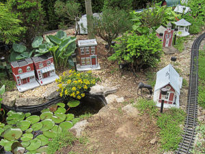 Our garden railroad looking north from the south end, after weeding in May, 2013.  Click for bigger photo.