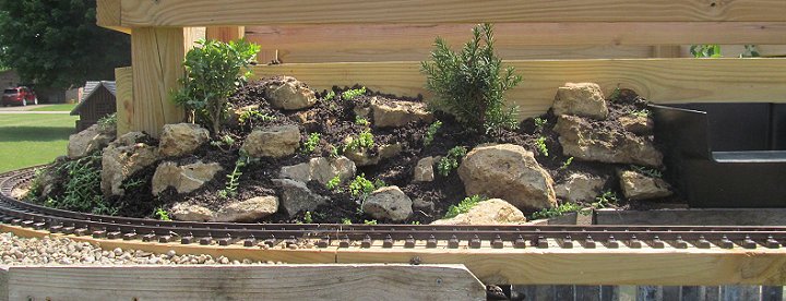 The northeast corner of the top layer after rocks, dirt, sedums, and dwarf trees have been put in place.  Click for bigger photo.