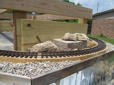 Testing rocks for a proper fit on the east end of the NEW New Boston and Donnels Creek raised garden railroad.  Click for bigger photo.