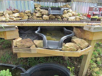 The third level of the waterfall on the NEW New Boston and Donnels Creek garden railway, with the trim boards and first layer of rocks installed.  Click for bigger photo