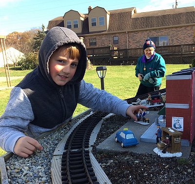 My oldest great-nephew setting out figures on the railroad.  Click for bigger photo.