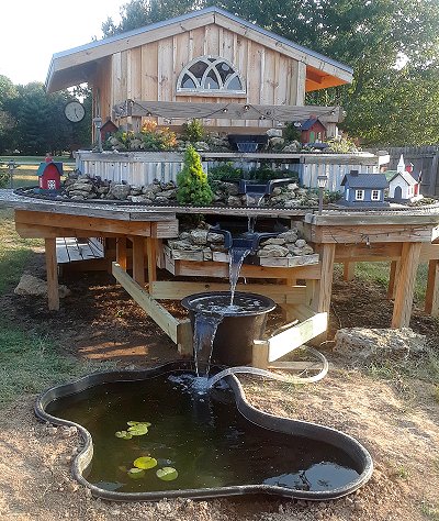 The frame for the last connecting pool is starting to take shape.  But for now, the 'wine barrel liner' is sitting where the connecting pool will sit, allowing me to run the waterfall and aerate the pond. Click for bigger photo.