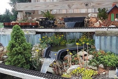An HLW 0-4-0T pulling a string of HLW mini gondolas on the top platform of the NEW New Boston and Donnels Creek RR, in April, 2020.  Click for bigger photo.
