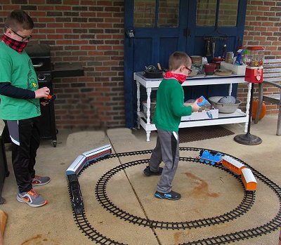 Two boys running Lionel's Ready-to-Play trains at the same time in the same place, something you can't do with Lionel's 'G gauge' battery-powered trains. Click for bigger photo.