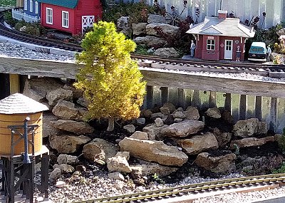 The northeast corner of the lower platform, now dirtscaped with rocks, dirt, sedum starts, and a Dwarf Alberta Spruce. Click for bigger photo.