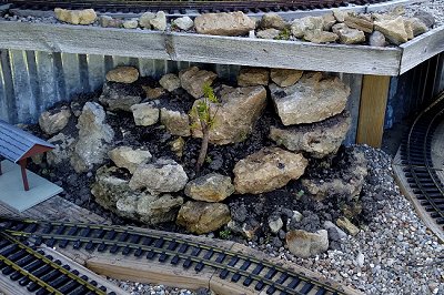 The southeast corner of the lower platform, now dirtscaped with rocks, dirt, sedum starts, and a Hicksii Taxus. Click for bigger photo.