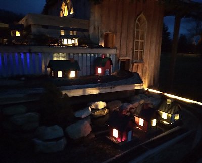 The 'winter buildings' on the west side of my railroad, winter of 2021-2022, shown after dark.  Click for bigger photo.