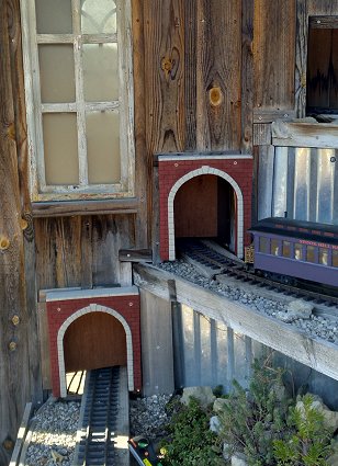 Two of the openings on the east side of the shed with portals and vertically sliding doors in place.  Trim, touchup, and other adjustments to come.  Click for bigger photo.
