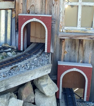Two of the openings on the west side of the shed with portals and vertically sliding doors in place.  Trim, touchup, and other adjustments to come.  Click for bigger photo.