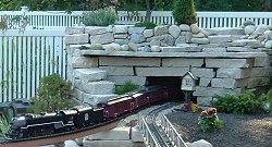 Alfred and Beverly Mann's railroad has a 'stacked stone' mountain on one end. Click for bigger photo.